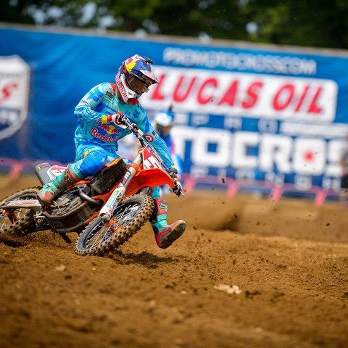 Motocross racer railing a berm